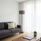 Modern lounge: slim 25cm base tucks neatly beside a sofa, daylight scene