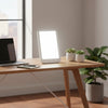 SAD light therapy lamp on modern desk workspace with MacBook - morning productivity
