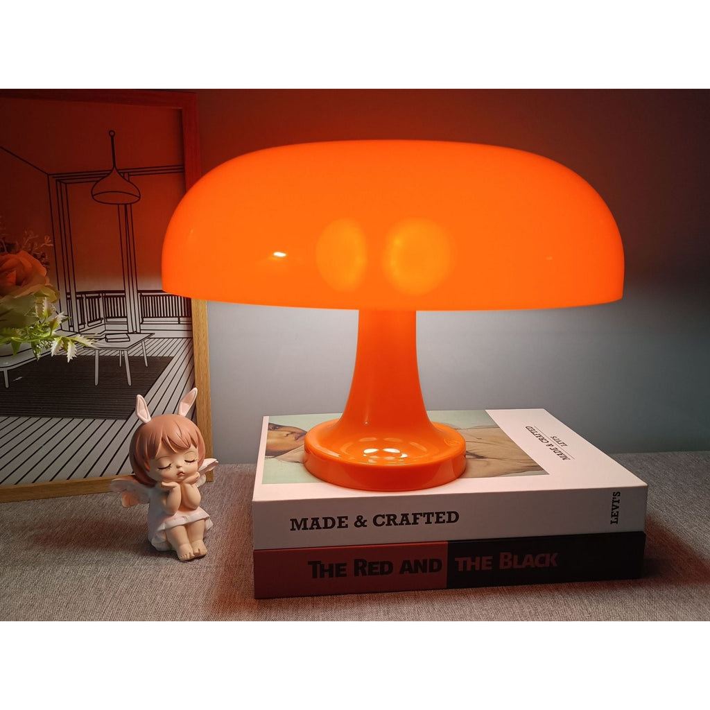 Orange Mushroom Desk Lamp Glowing on Books