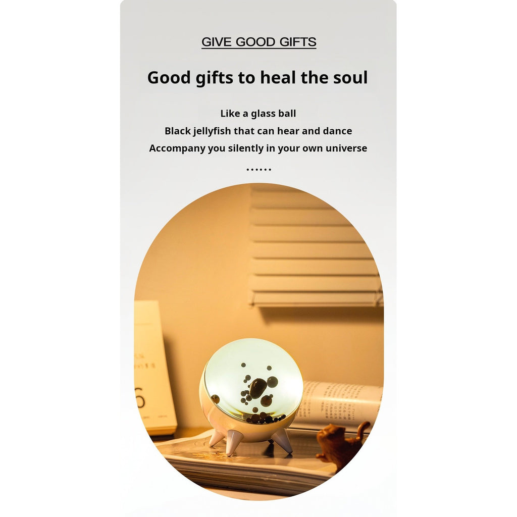Ferrofluid music lamp in desktop lifestyle setting showing glow effect