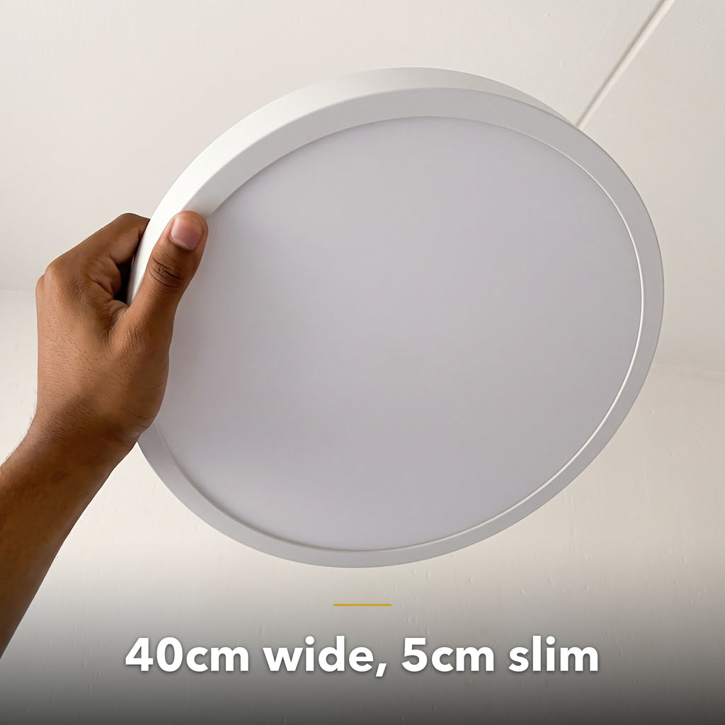 40cm white slim round LED ceiling light, held in hand to show its size