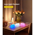 LED heart keychain lights all three colours glowing on table
